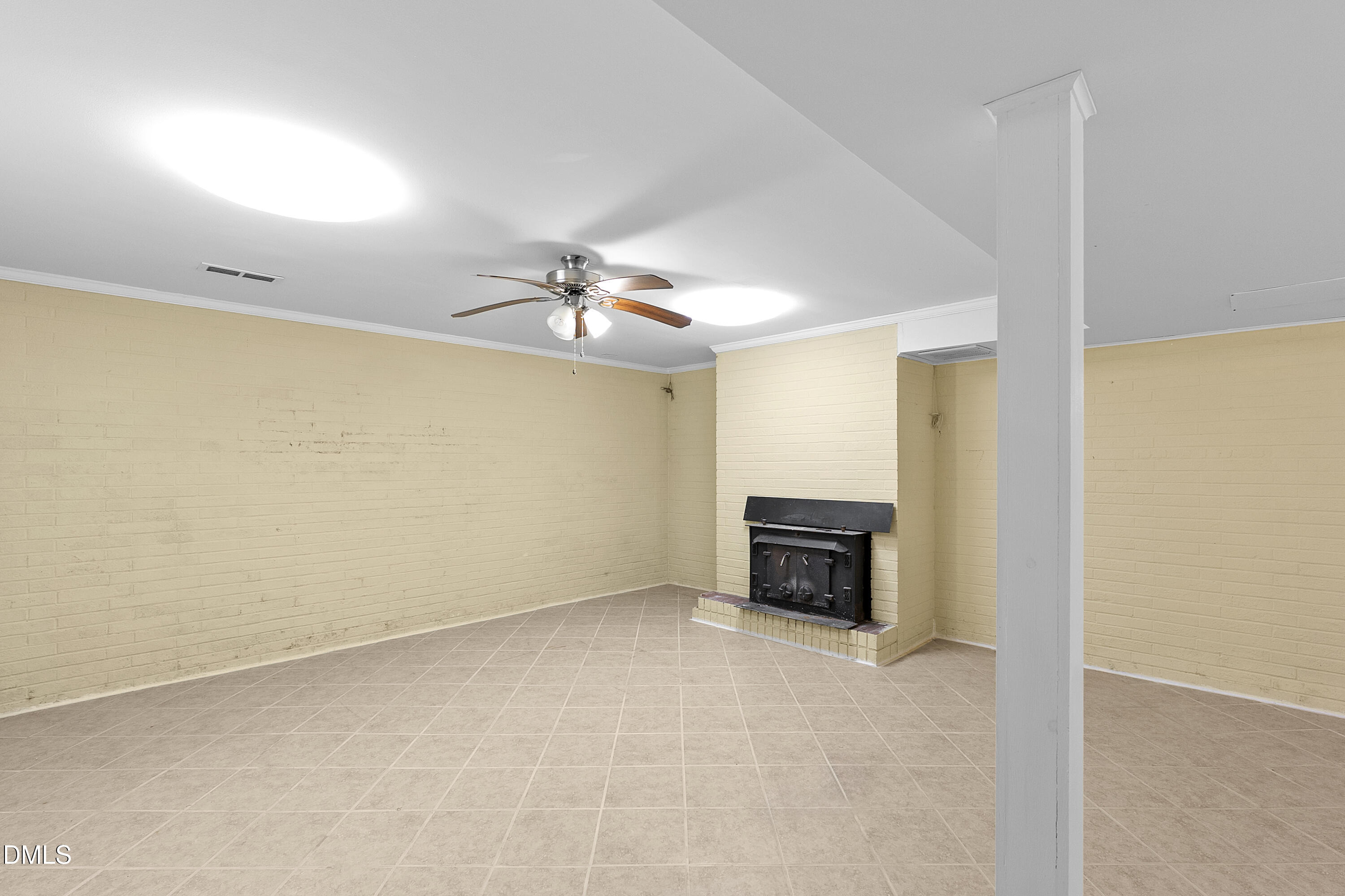 5575 Straw Pond School Road Godwin, NC 28344 - Photo 14 of 66 an empty room with a fireplace and a chandelier fan