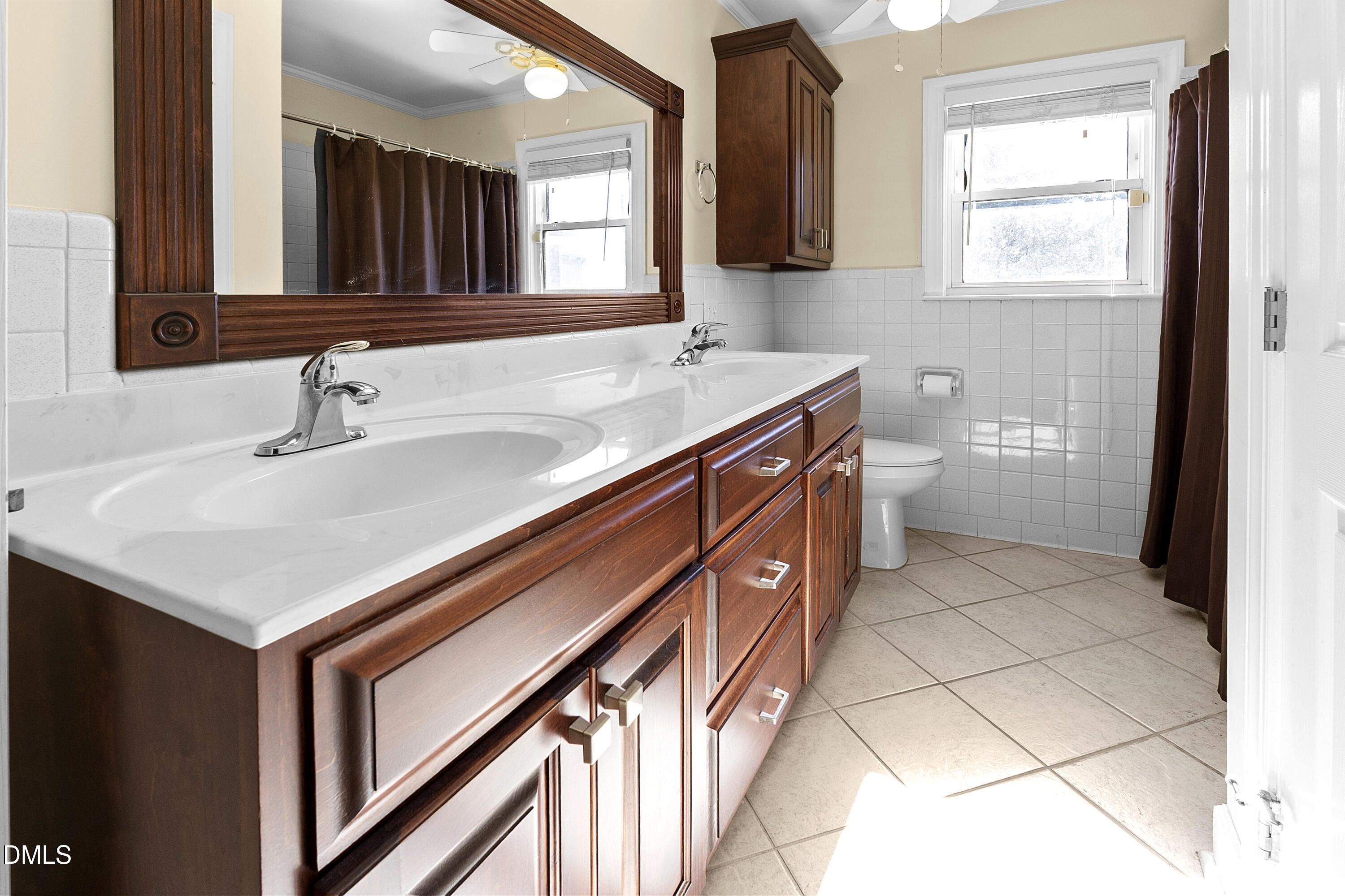 5575 Straw Pond School Road Godwin, NC 28344 - Photo 19 of 66 a bathroom with a sink a toilet a mirror and a window