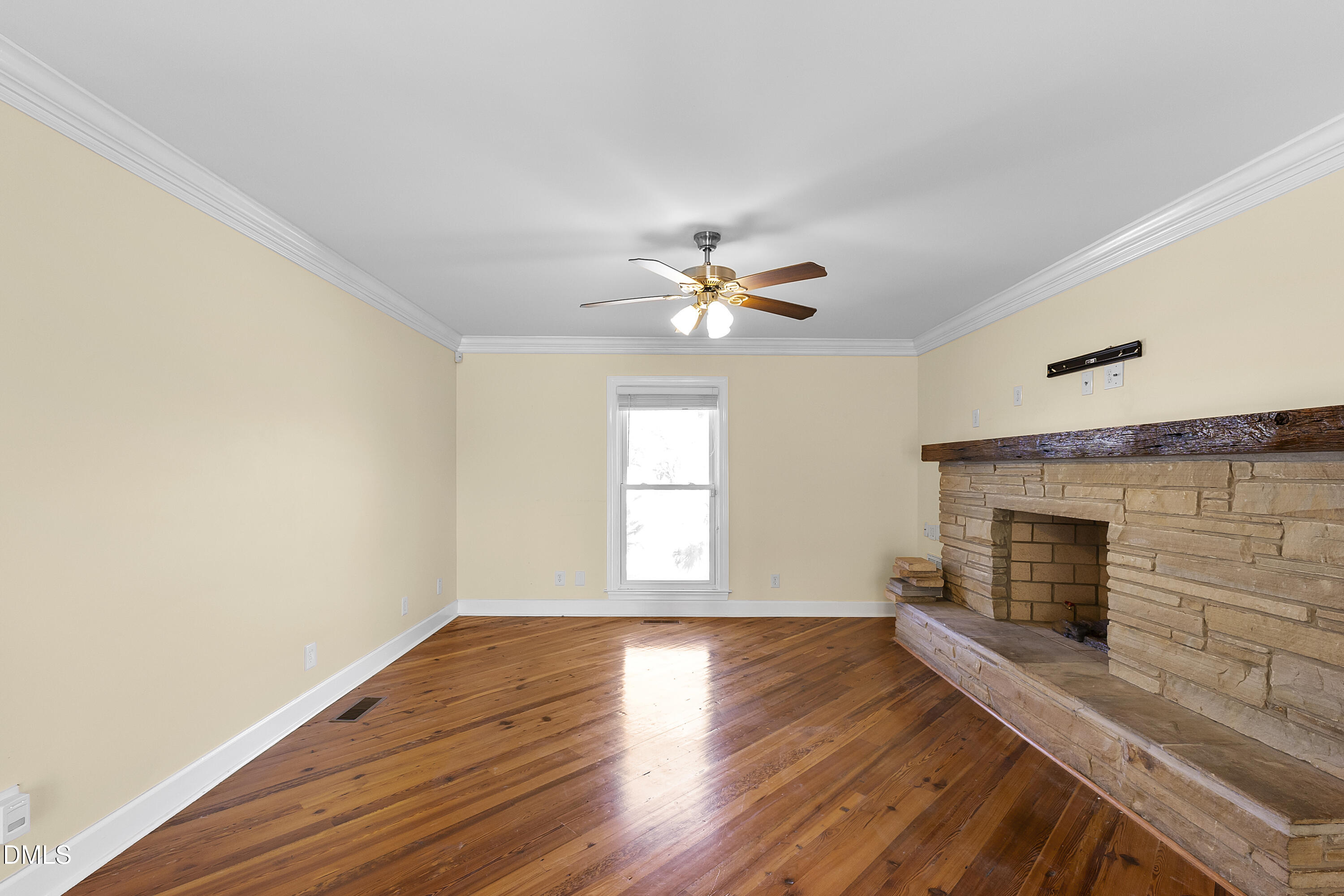 5575 Straw Pond School Road Godwin, NC 28344 - Photo 30 of 66 a view of an empty room with wooden floor fireplace and a window