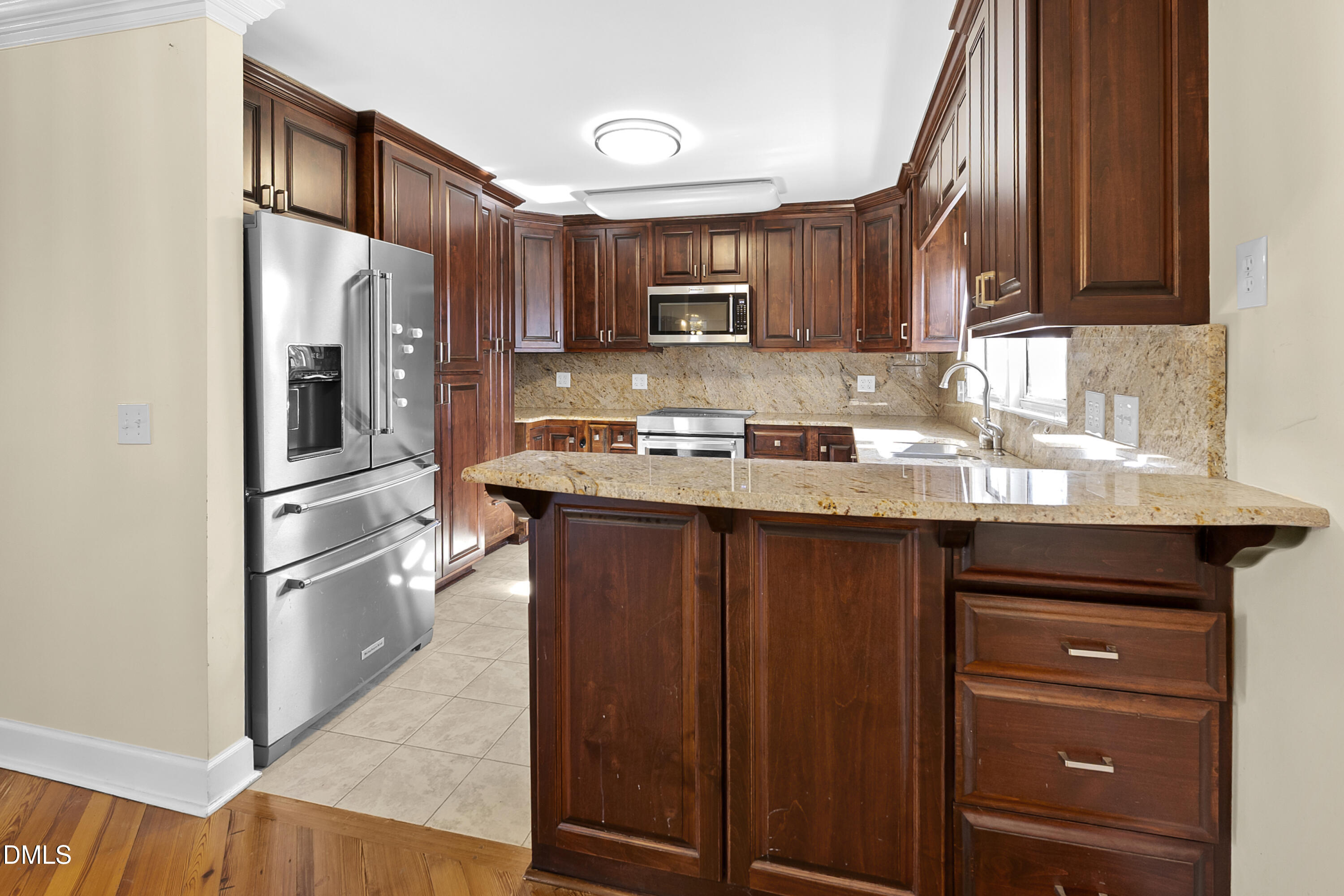 5575 Straw Pond School Road Godwin, NC 28344 - Photo 38 of 66 a kitchen with stainless steel appliances granite countertop a refrigerator and a sink