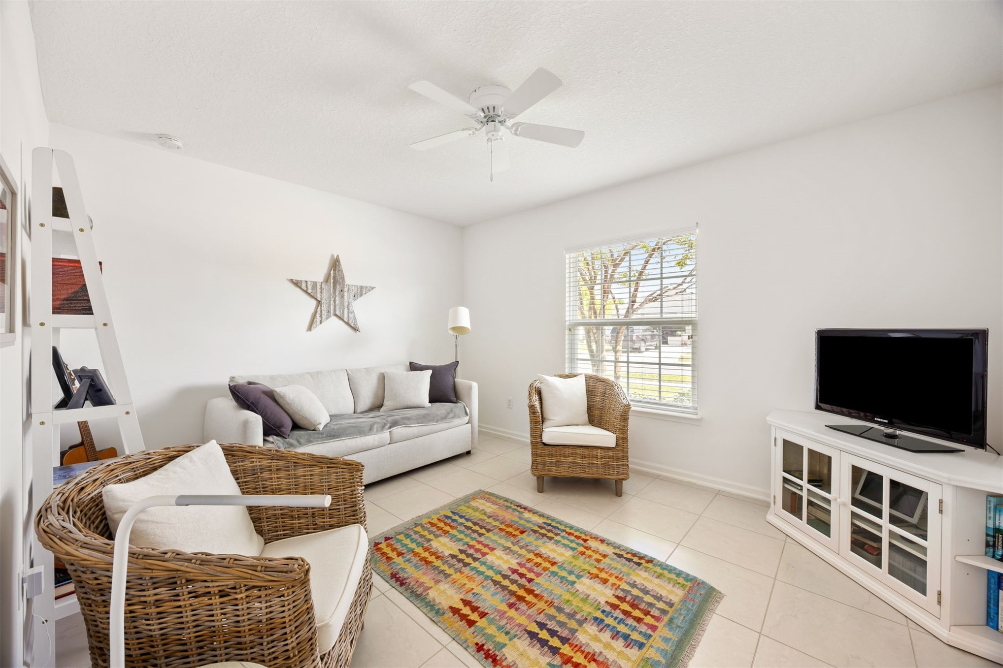 94037 Last Lane Yulee, FL 32097 - Photo 27 of 38 a living room with furniture and a flat screen tv