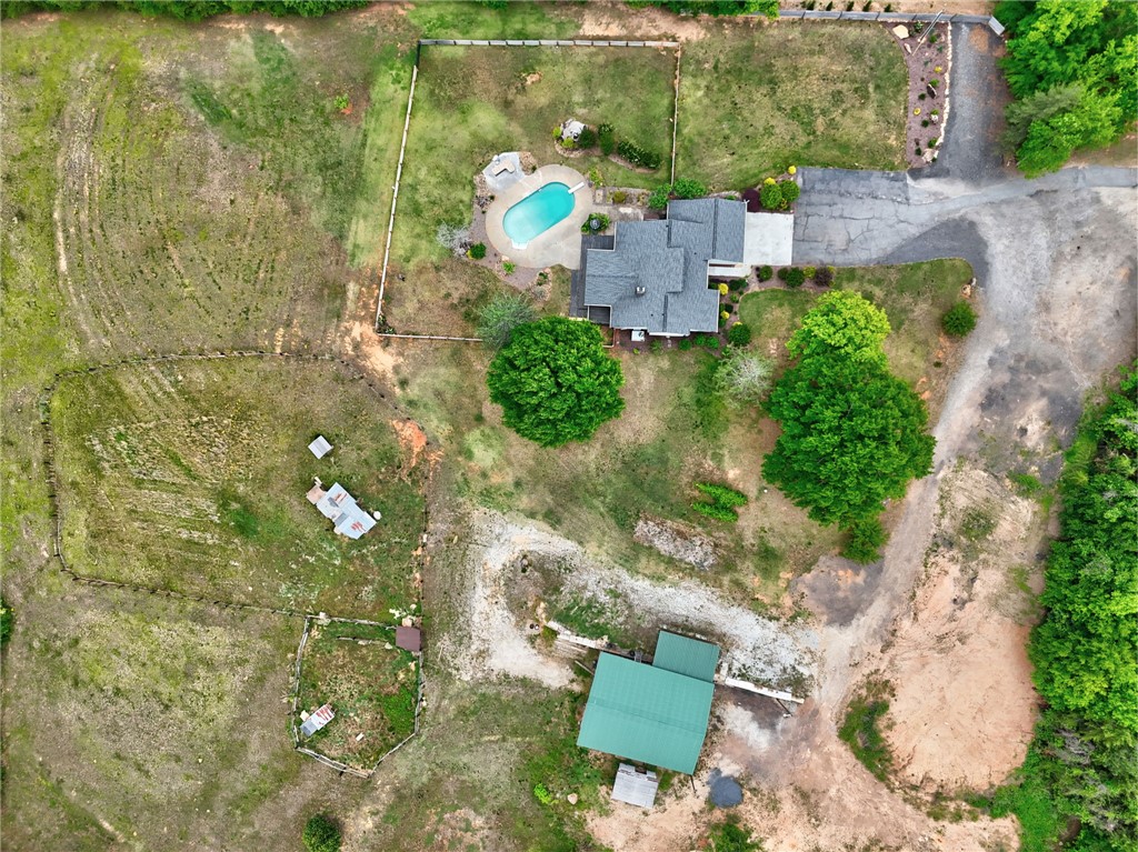 433 Latham Road Easley, SC 29640 - Photo 36 of 50 An aerial perspective reveals a serene property featuring a private pool and outbuildings nestled amongst verdant landscapes.