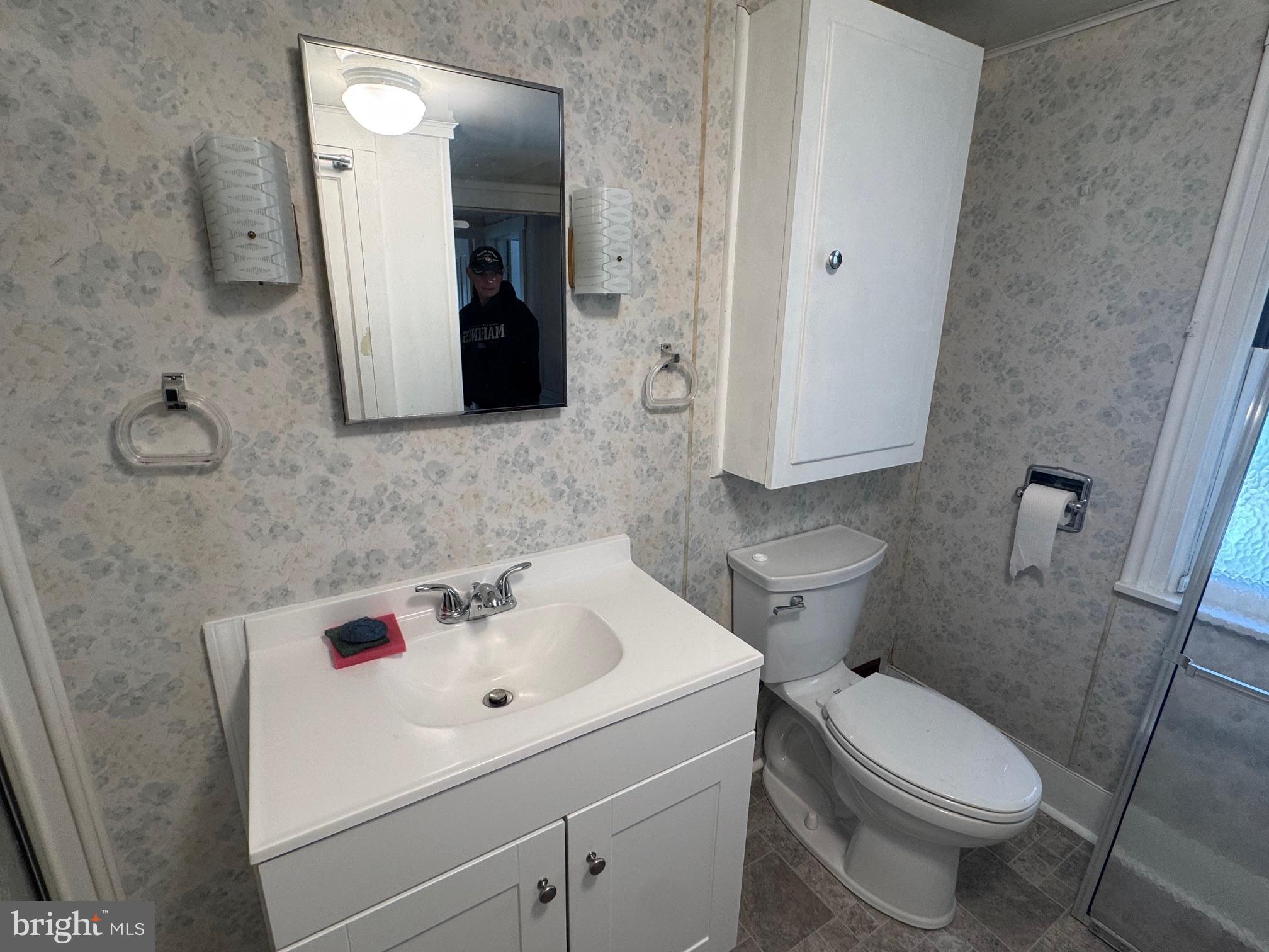 18250 South Fork Road Moorefield, WV 26836 - Photo 22 of 76 a white toilet sitting next to a bathroom sink