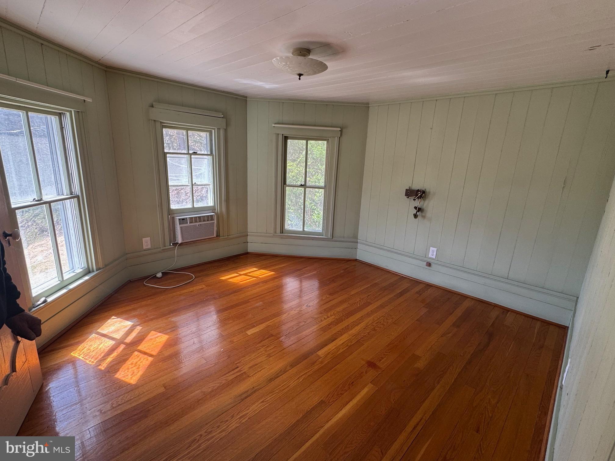 18250 South Fork Road Moorefield, WV 26836 - Photo 30 of 76 an empty room with wooden floor and windows
