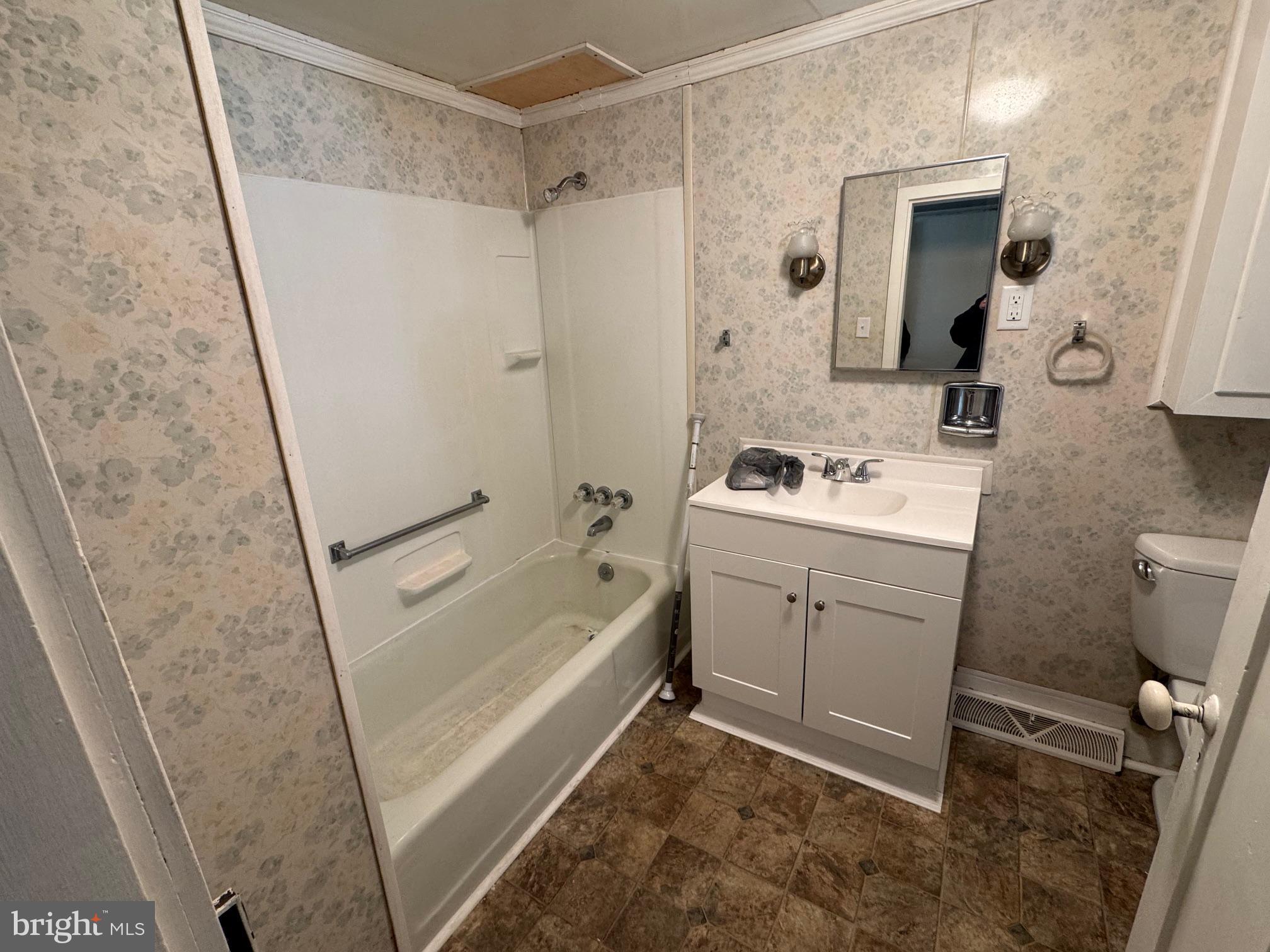 18250 South Fork Road Moorefield, WV 26836 - Photo 9 of 76 a bathroom with a sink a toilet a mirror a vanity and shower