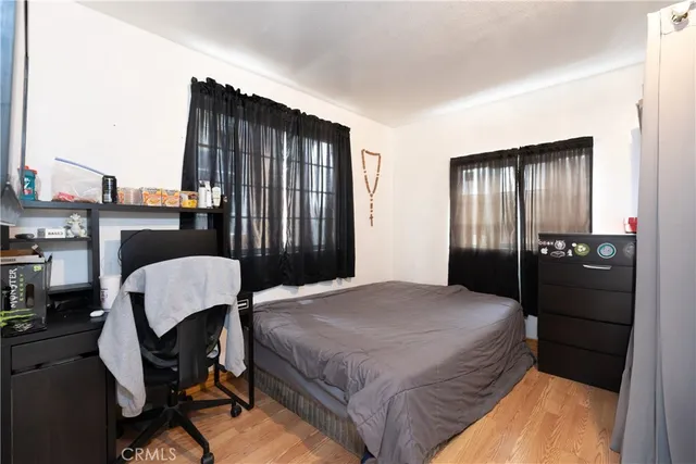 a bedroom with a bed chair and window