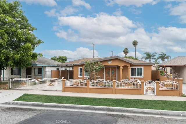 a front view of a house with a yard table and chairs