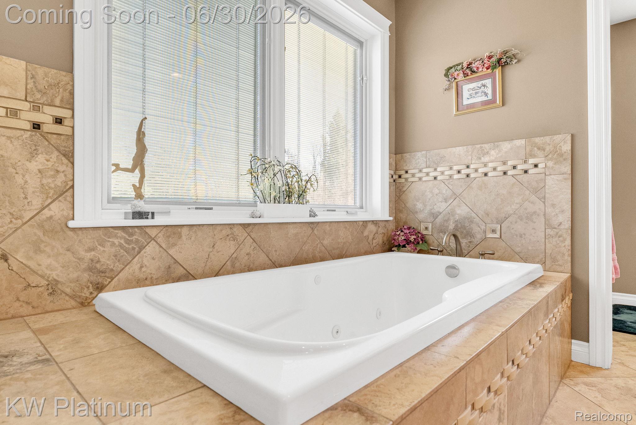 2235 South Lake Shore Road Harbor Beach, MI 48441 - Photo 35 of 99 Built-in soaking tub with jetted features, surrounded by large format tile with mosaic accents and a window with blinds