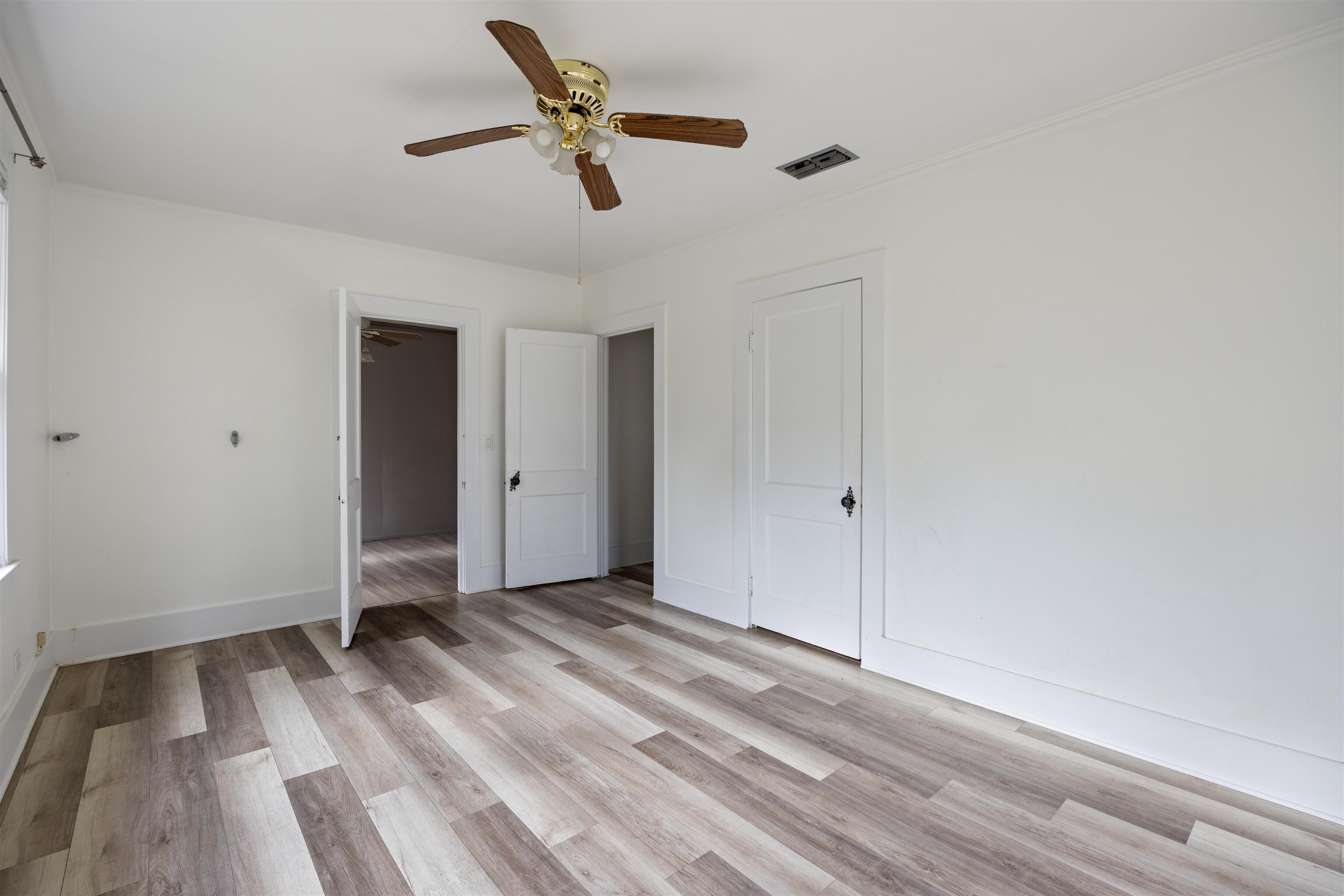 112 South Juniper Street Foley, AL 36535 - Photo 46 of 64 Unfurnished bedroom with light wood-type flooring and a ceiling fan