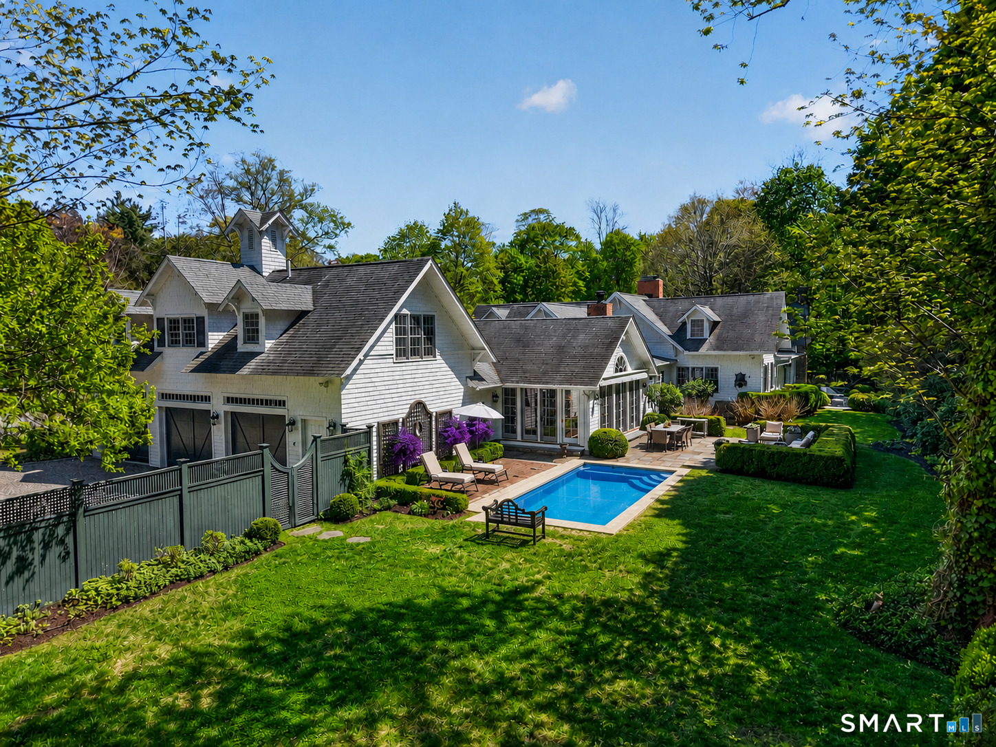 41 Peaceable Street Ridgefield, CT 06877 - Photo 35 of 40 a view of a house with a big yard and large trees