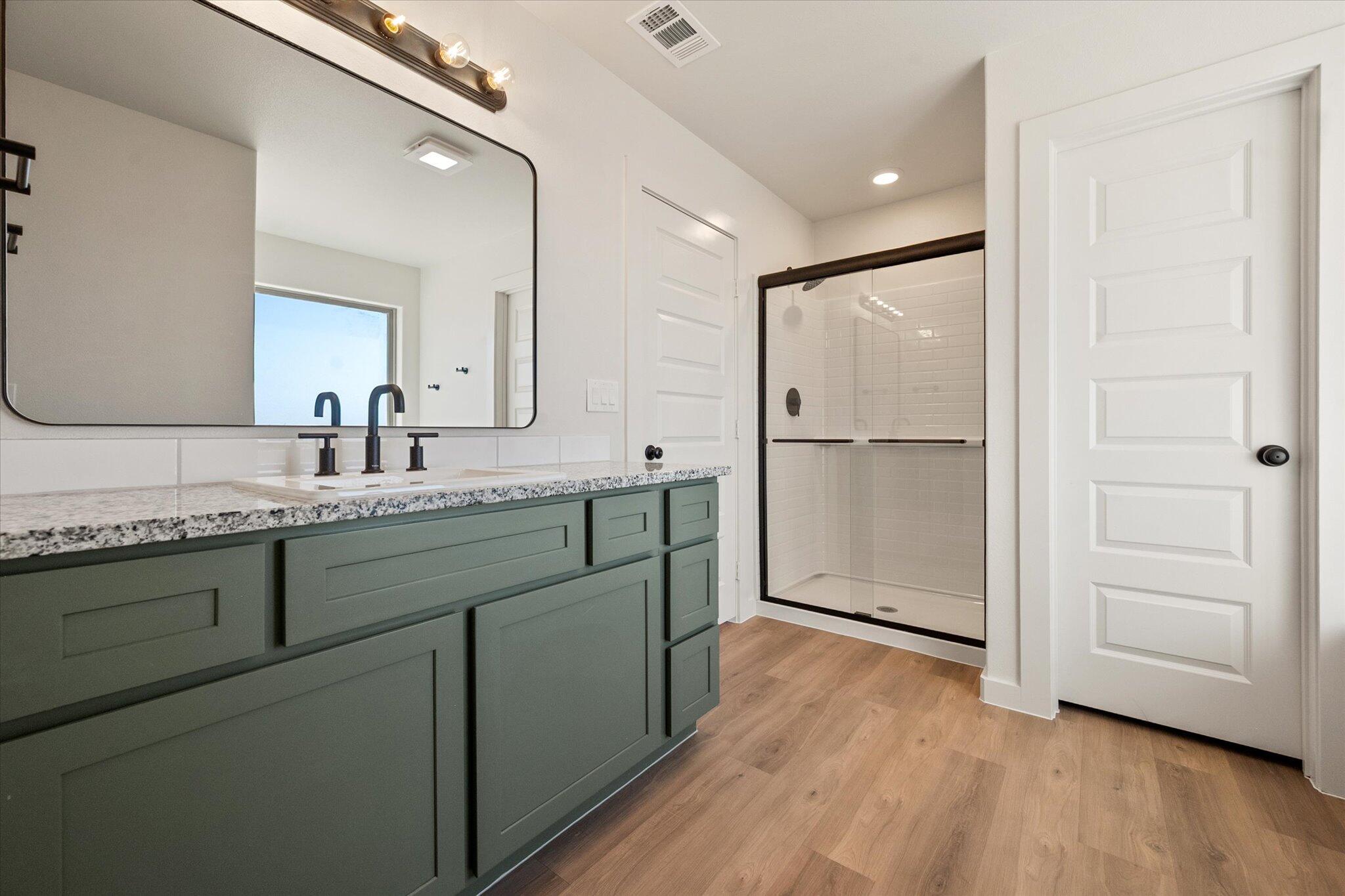602 East 22nd Street Wolfforth, TX 79382 - Photo 14 of 22 a bathroom with a double vanity sink and mirror