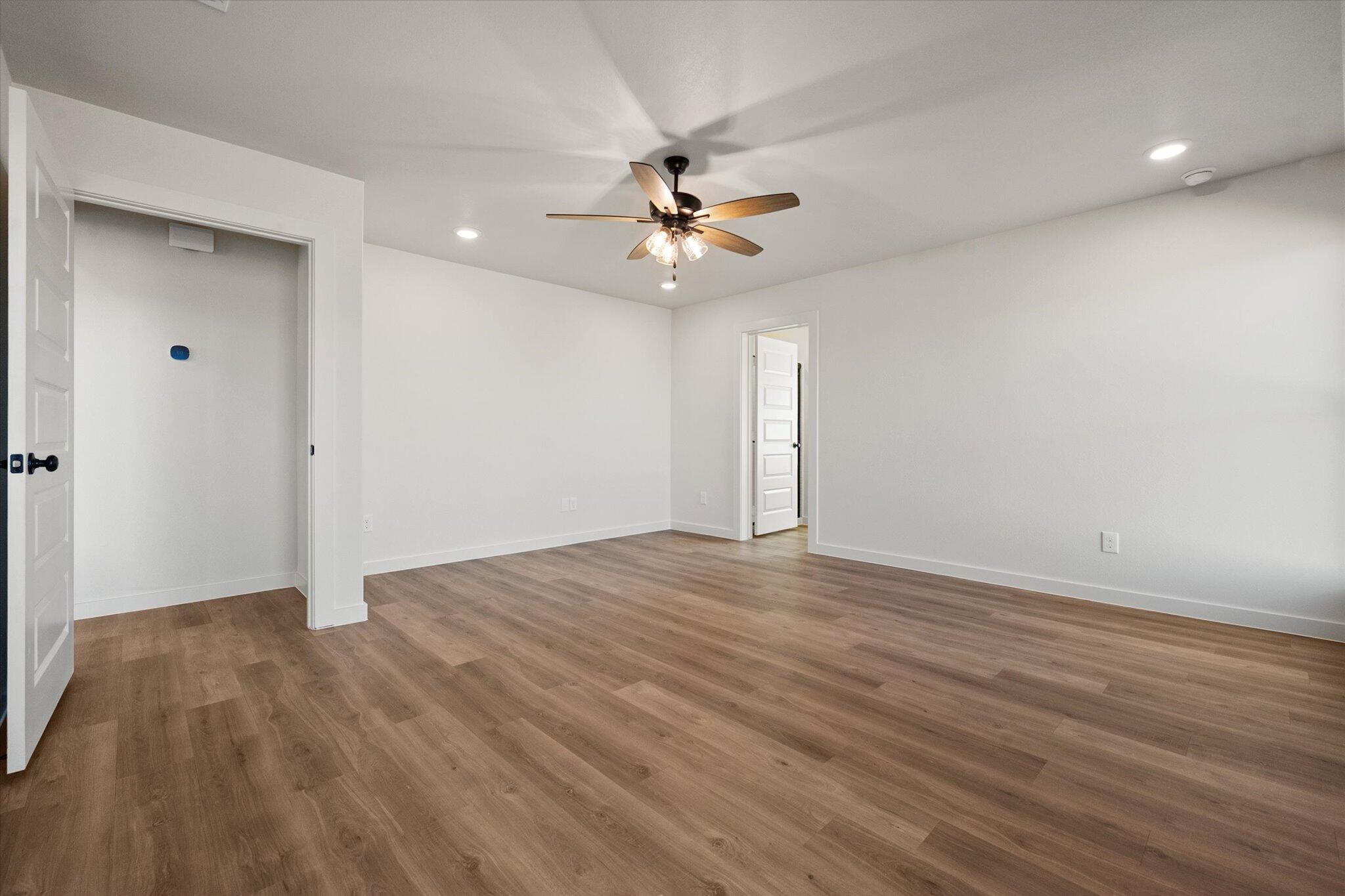 602 East 22nd Street Wolfforth, TX 79382 - Photo 15 of 22 wooden floor in an empty room with a window