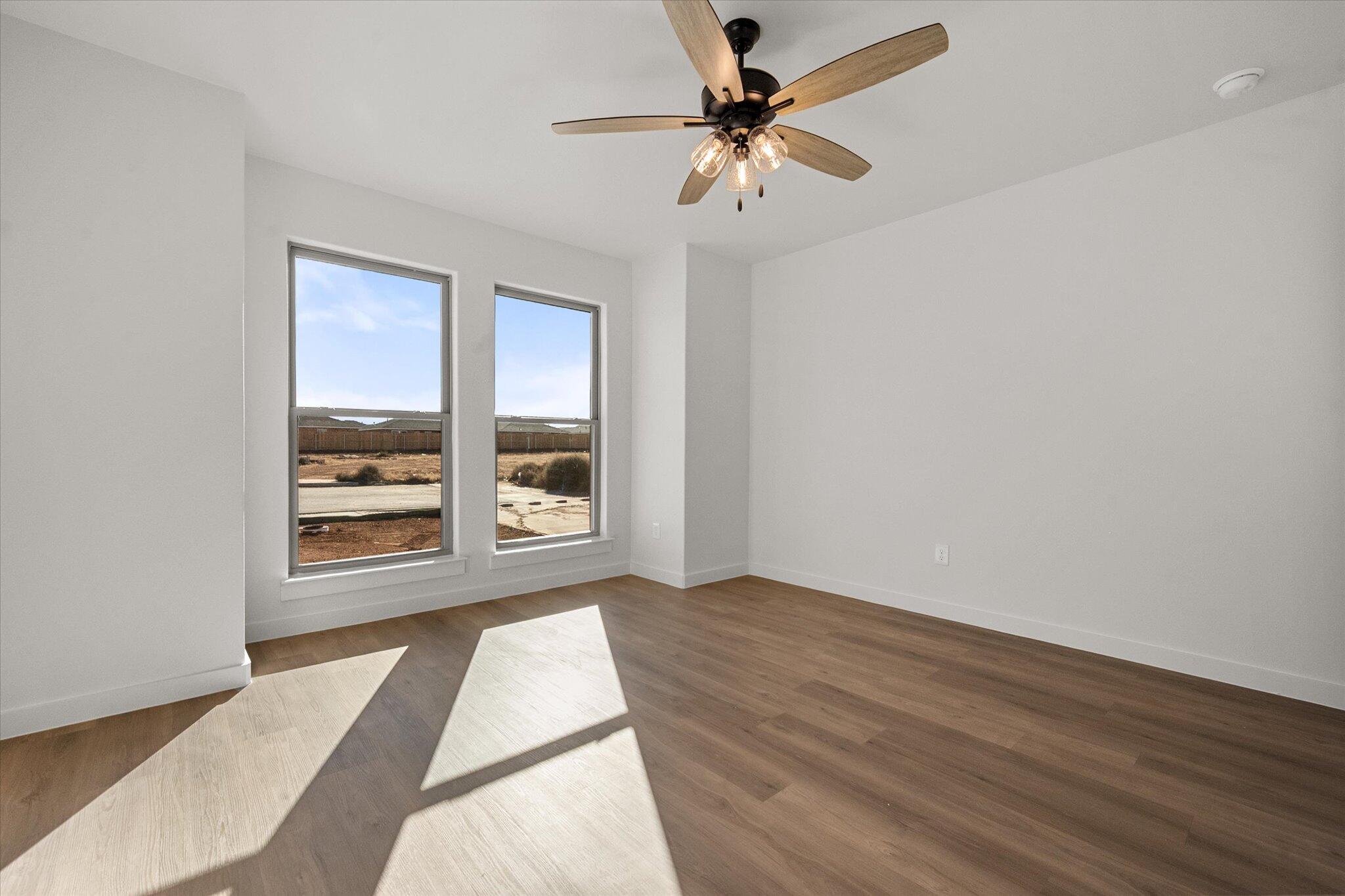 602 East 22nd Street Wolfforth, TX 79382 - Photo 17 of 22 wooden floor in an empty room with a window
