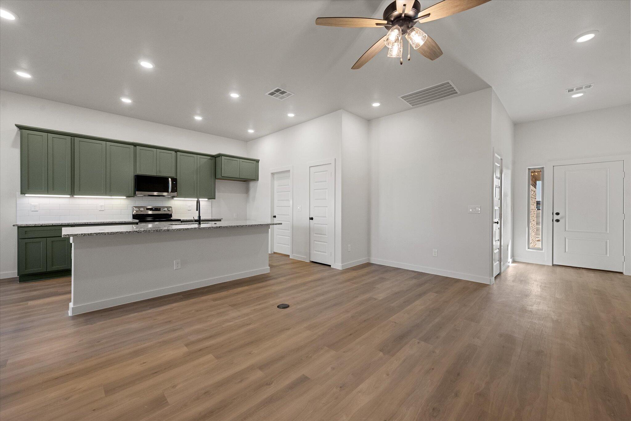 602 East 22nd Street Wolfforth, TX 79382 - Photo 6 of 22 a view of kitchen with granite countertop cabinets and stainless steel appliances