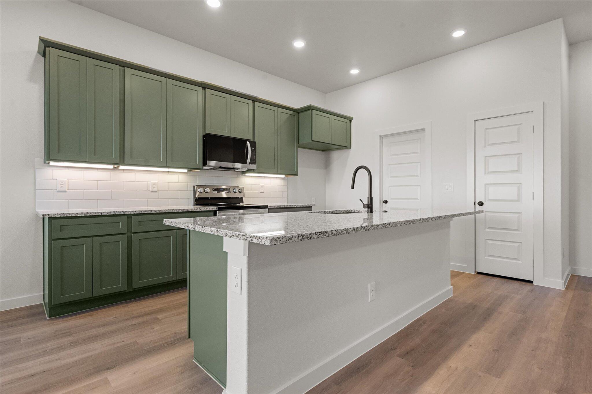 602 East 22nd Street Wolfforth, TX 79382 - Photo 7 of 22 a kitchen with granite countertop a sink and cabinets