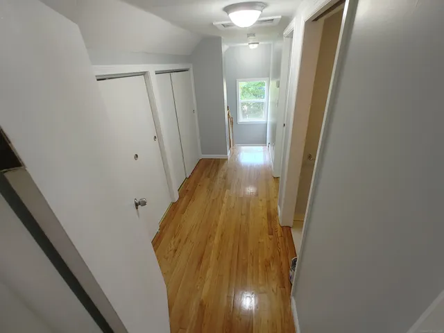 a view of a bathroom from a hallway