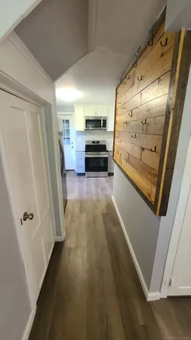 a view of a hallway view with wooden floor and staircase