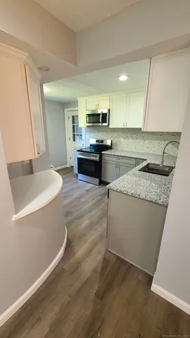 a kitchen with a sink and a stove top oven