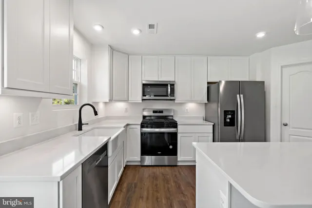 a kitchen with a sink a stove and refrigerator