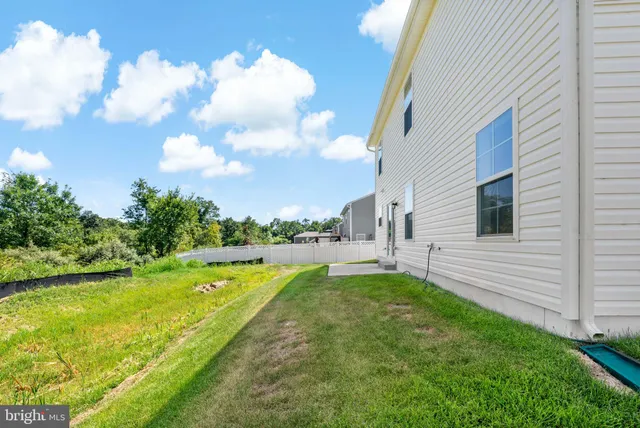 a view of a white house with swimming pool in front of it