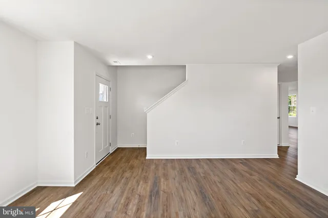 a view of wooden floor and windows in a room