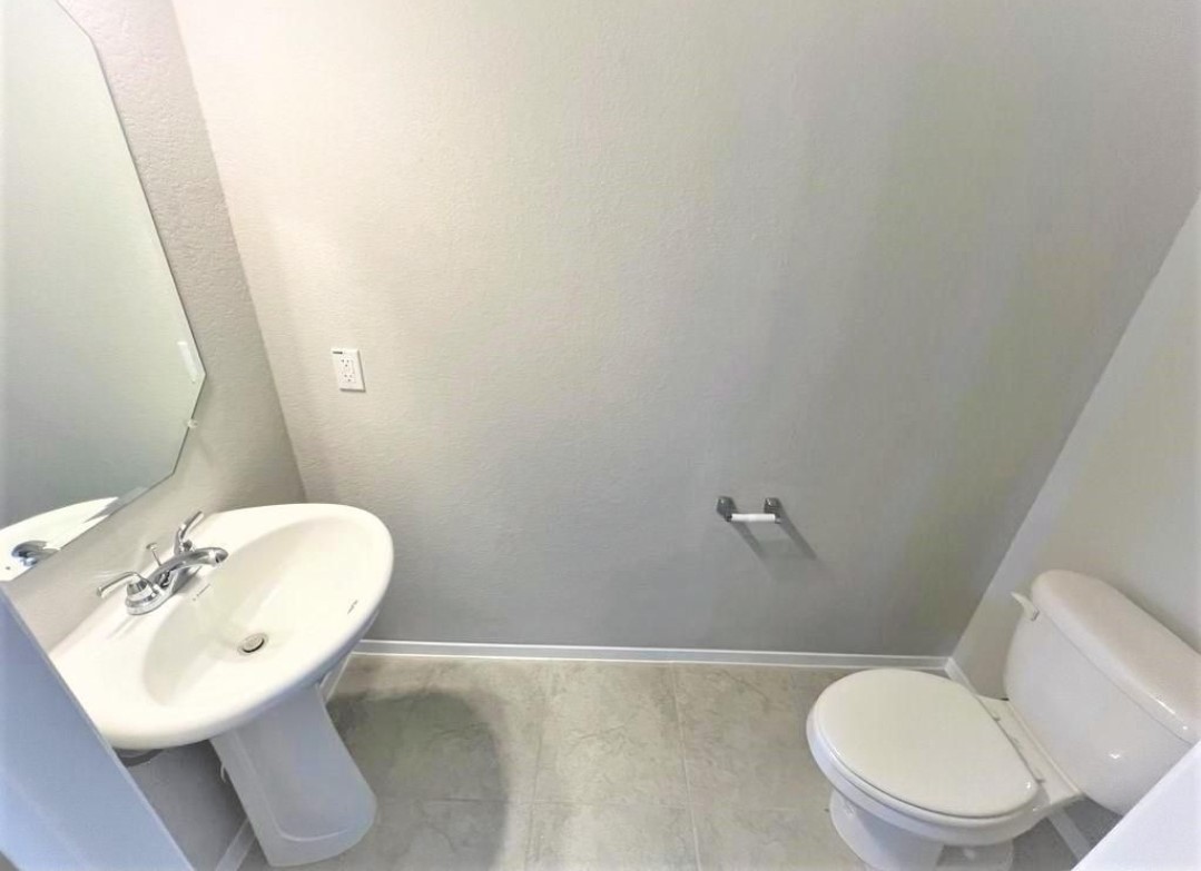 2771 Winding Creek Road Kyle, TX 78640 - Photo 12 of 24 Functional and minimalist, this restroom offers essential amenities for everyday convenience.
