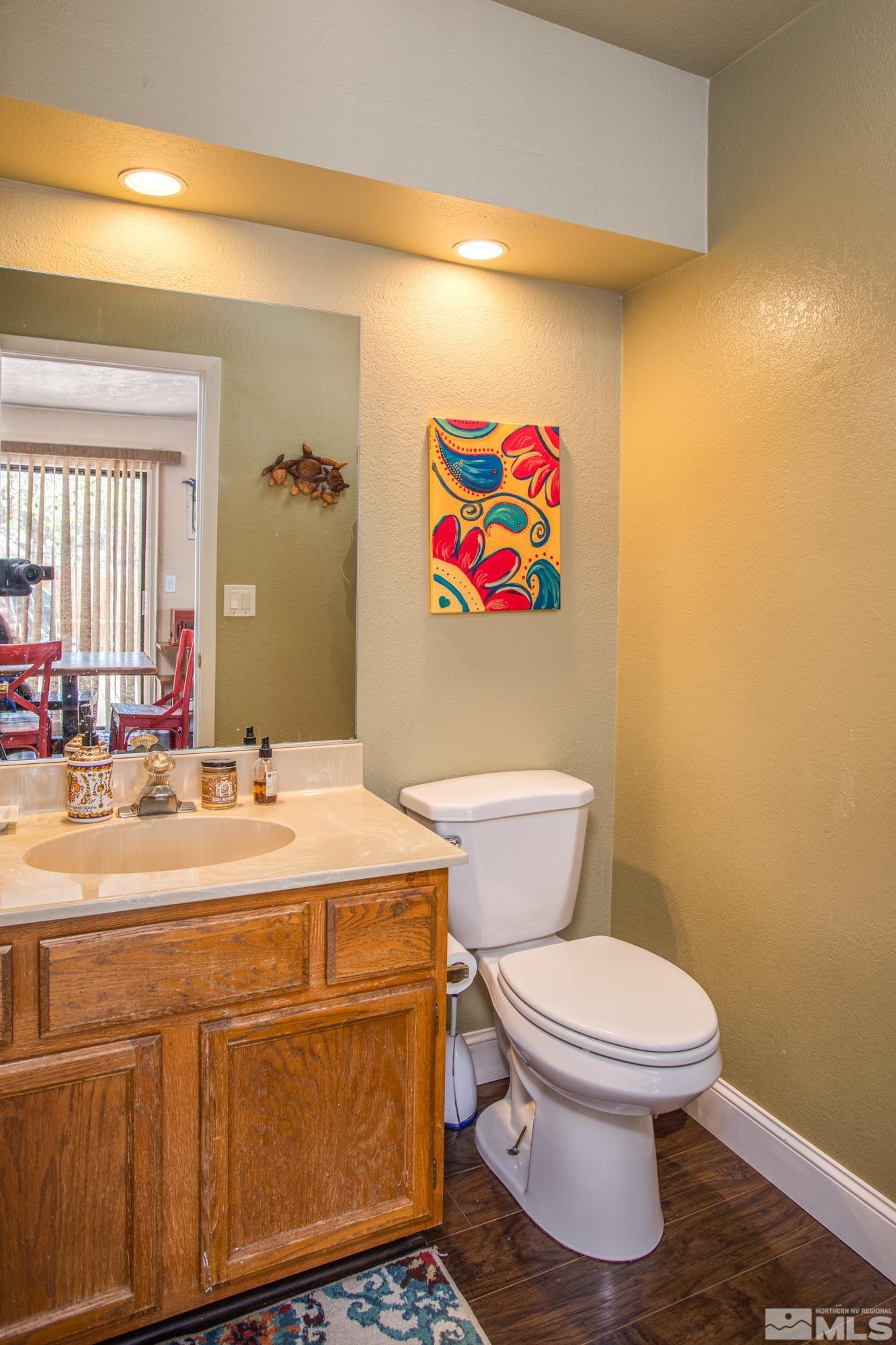 3980 Kings Row Reno, NV 89503 - Photo 13 of 35 a bathroom with a sink a toilet a vanity and mirror