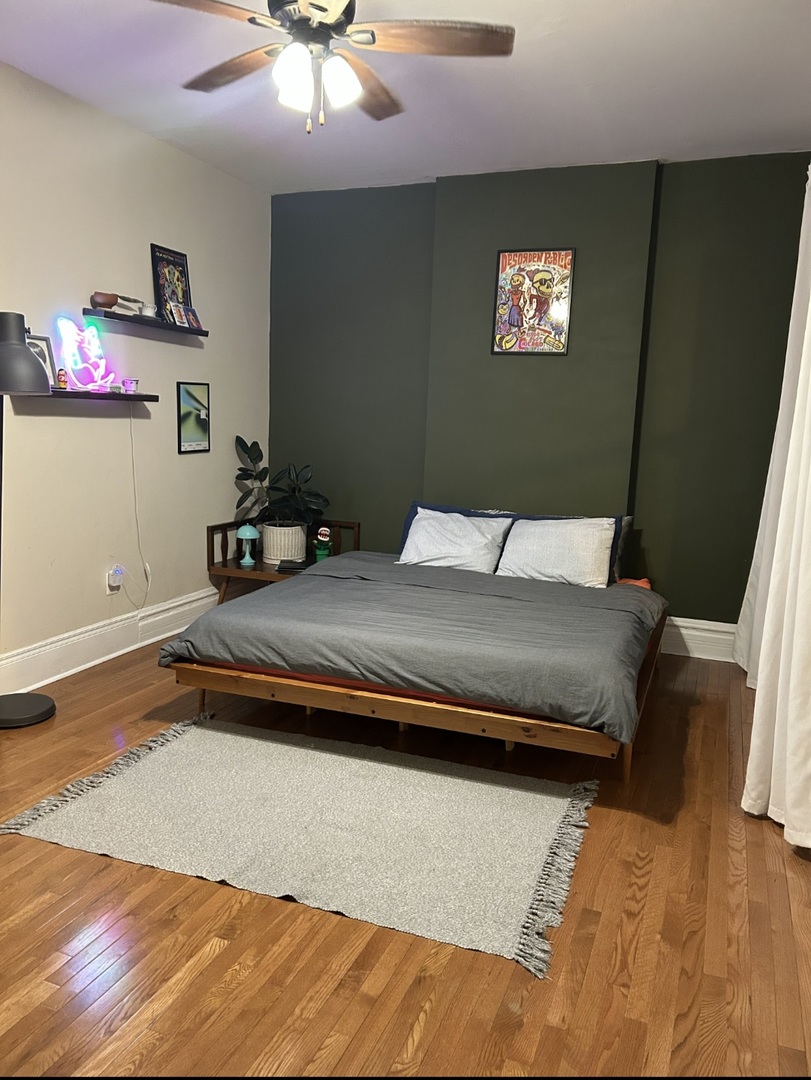 1332 West 18th Street, Unit 3F Chicago, IL 60608 - Photo 3 of 5 a bedroom with a bed and a flat screen tv