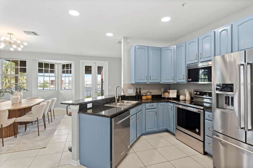 1450 Harbour Walk Road Tampa, FL 33602 - Photo 2 of 26 a kitchen with granite countertop a sink stainless steel appliances and cabinets