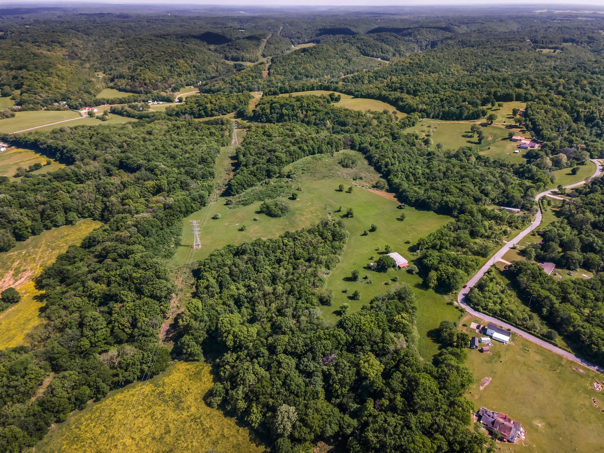 8475 Crawley Hill Road Mount Pleasant, TN 38474 - Photo 3 of 41 an aerial view of mountain with residential house and green space