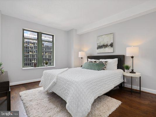 1150 K Street Northwest, Unit 709 Washington, DC 20005 - Photo 20 of 25 a bedroom with a bed and wooden floor