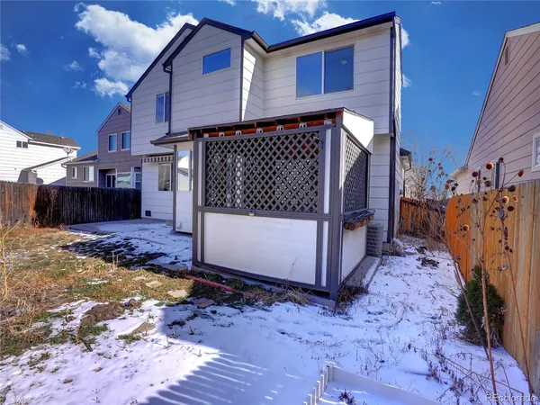 a view of a house with wooden fence