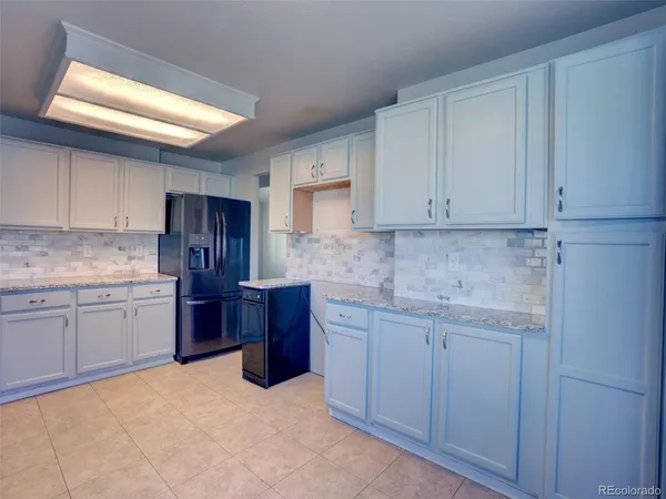 a kitchen with stainless steel appliances granite countertop a sink and cabinets