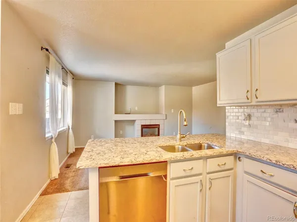 a kitchen with granite countertop a sink and cabinets