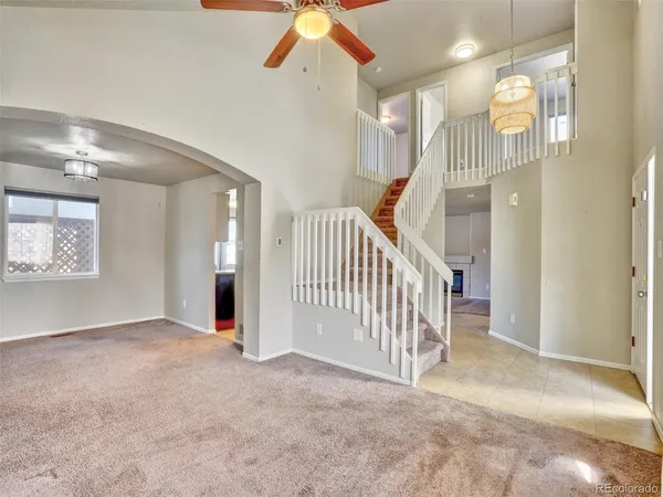 a view of a hallway with entryway and stairs