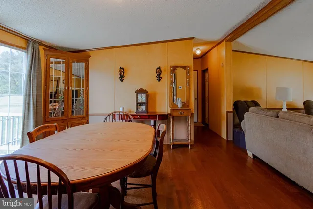 a view of a dining room with furniture and window
