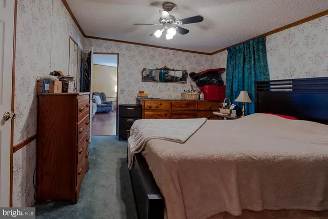 a bed room with a bed and a chandelier