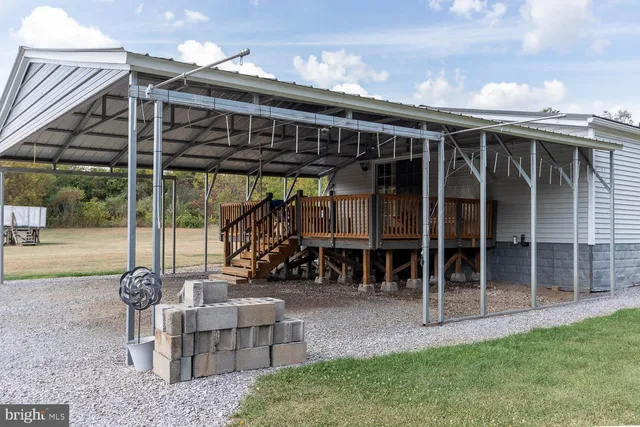 a view of a patio with table and chairs and potted plants