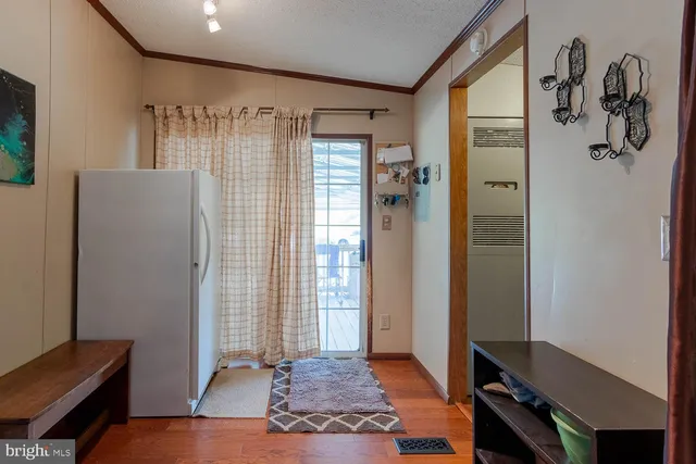 a view of a hallway with workspace and a window