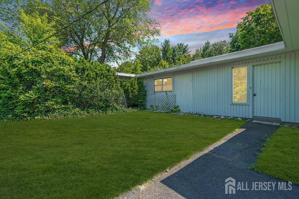 21 Homestead Lane Roosevelt, NJ 08555 - Photo 1 of 24 a view of a backyard with potted plants and large tree