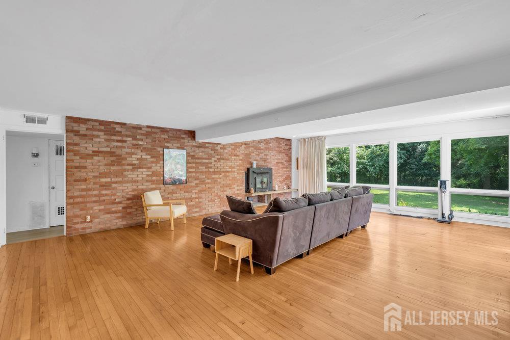 21 Homestead Lane Roosevelt, NJ 08555 - Photo 11 of 24 a living room with furniture large windows and wooden floor