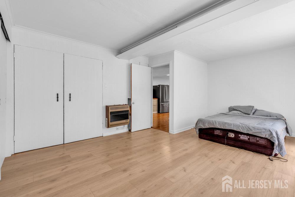 21 Homestead Lane Roosevelt, NJ 08555 - Photo 13 of 24 a spacious bedroom with a bed and a view of kitchen