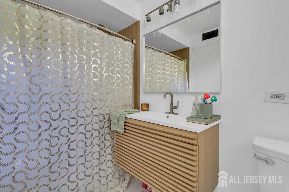 21 Homestead Lane Roosevelt, NJ 08555 - Photo 14 of 24 a bathroom with a sink and a mirror