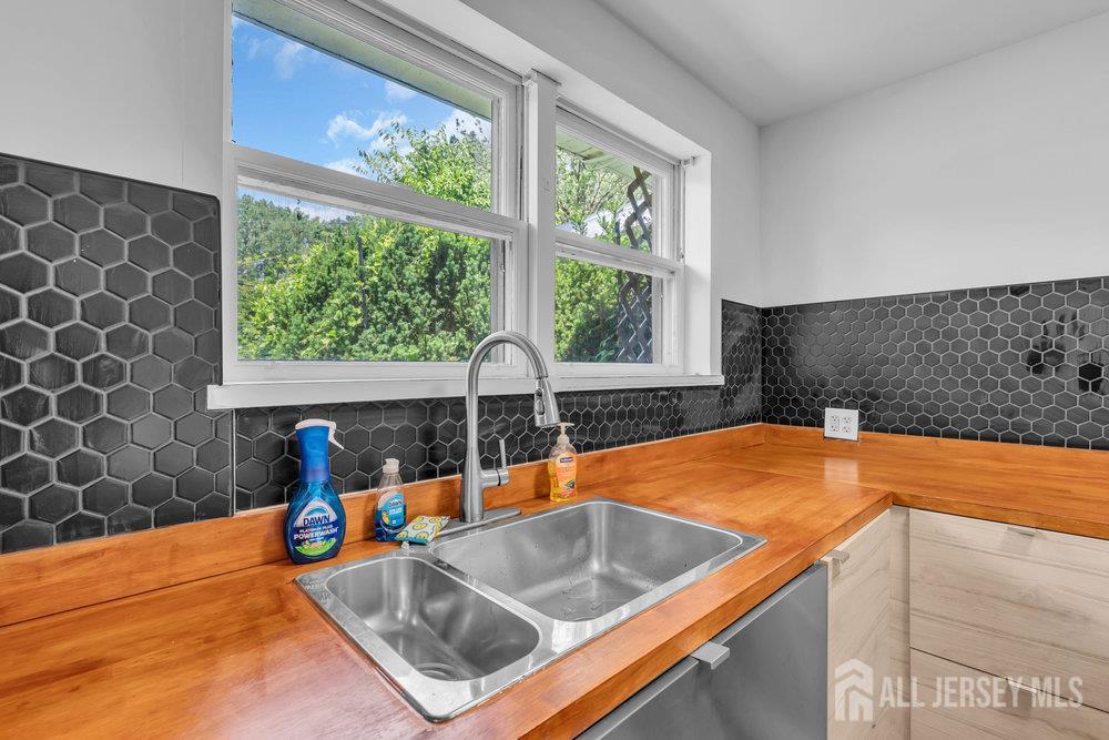 21 Homestead Lane Roosevelt, NJ 08555 - Photo 8 of 24 a kitchen with stainless steel appliances granite countertop a sink and a window