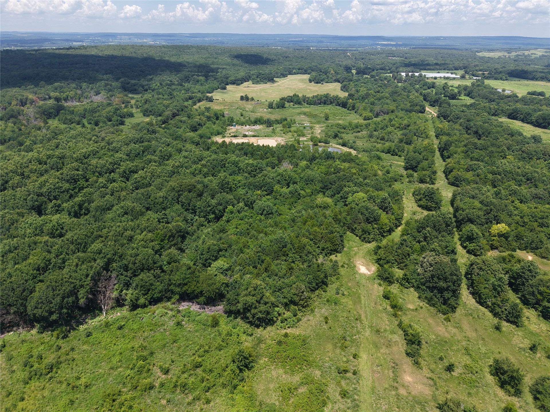33594 Johnson Shady Point Shady Point, OK 74956 - Photo 13 of 18 Expansive natural landscape featuring mature trees, open clearings, and distant bodies of water