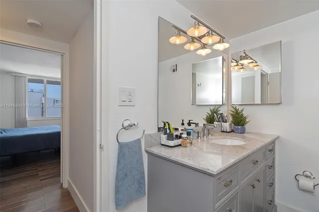 a bathroom with a sink vanity and a mirror