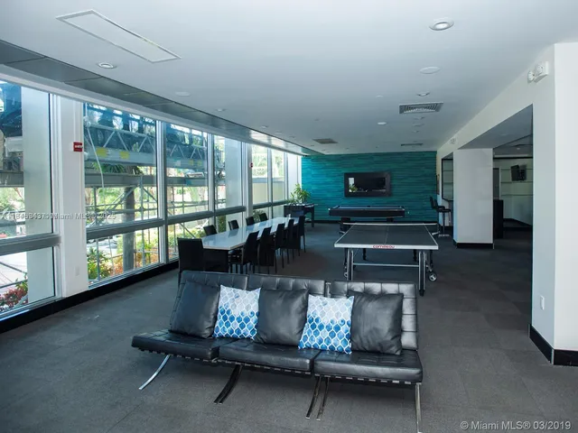 a kitchen with a table chairs sink and cabinets