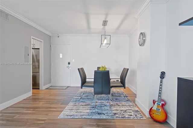 a view of a dining room with furniture and wooden floor