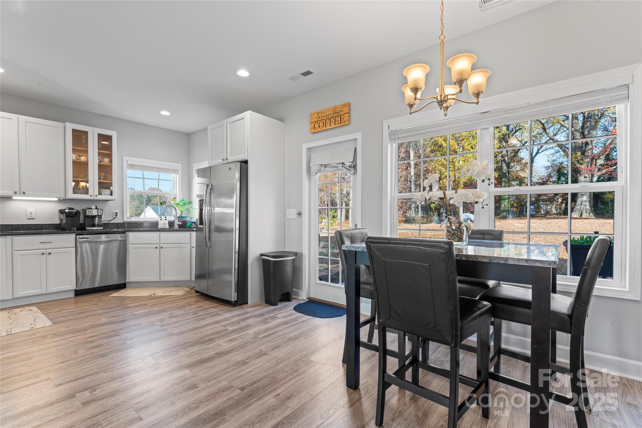 3839 Robinson Circle Gastonia, NC 28056 - Photo 13 of 46 a kitchen with stainless steel appliances a dining table chairs and refrigerator