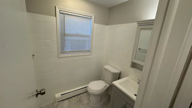 a white toilet sitting next to a small sink